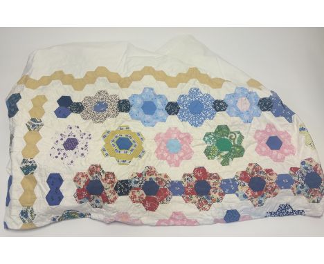 A flower head honey-comb patch work bedcover, on white cotton, some signs of staining. (167cmx231cm)