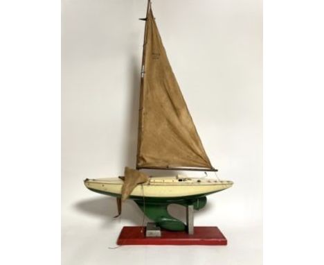 A Triang vintage pond sailing yacht with wooden masts and linen sails raised on a painted wooden stand (h. incl stand 105cm x