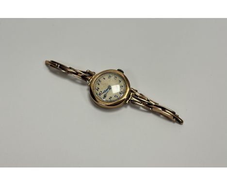 A Vintage 9ct gold wristwatch with gilt dial and arabic numerals on Britannic yellow metal expanding bracelet: d x 2cm 16.7g 