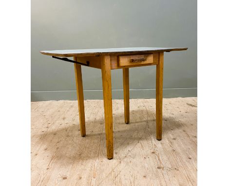 A vintage 1950s formica top drop leaf kitchen table with celadon coloured formica, fitted single drawer, on square tapered su