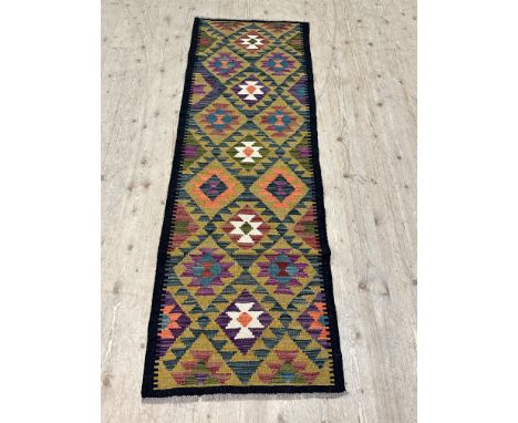A maimana kilim runner, with colourful lozenge motifs encased with a black border, 190cm x 64cm 