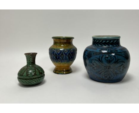 A collection of glazed pottery comprising, an Iznic pottery glazed jar in bulbous form and slip-painted with black floral dec