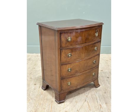 A mahogany bow front bedside chest fitted four long drawers, on splay bracket feet, with brass ring handles (h.73cm x l.55cm 