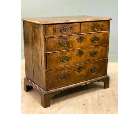 An 18thc walnut veneered chest with herringbone crossbanded top, fitted two short and three graduated long drawers, on moulde