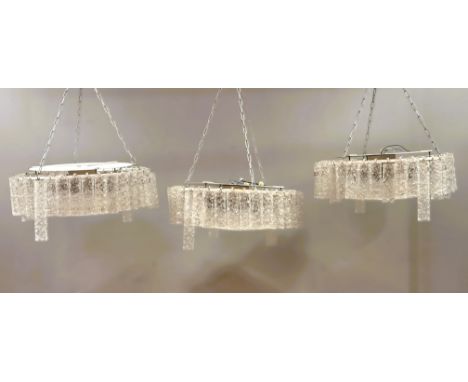 A set of three 1960s -70s Doria of Germany circular white enamel framed pendant lights with Murano Venini hand -blown clear f