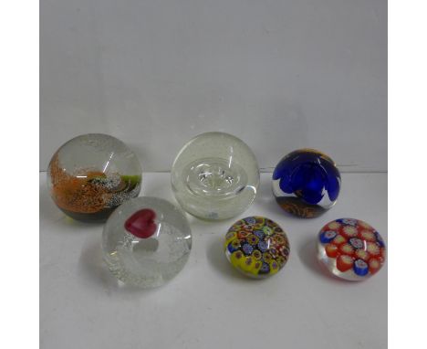 Four Caithness glass paperweights and two millefiori paperweights 