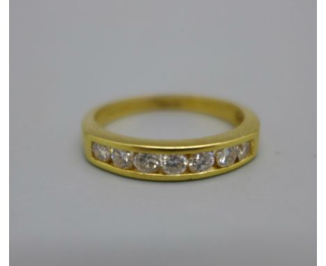 An 18ct gold, seven stone brilliant cut diamond half eternity ring, 0.5ct diamond weight marked on the shank, 3.2g, O 