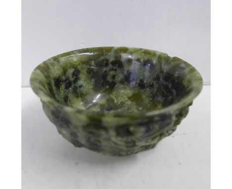A Chinese spinach jade marriage bowl, depicting two dragons, chip to rim, circa 1900 