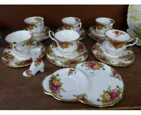 Six Royal Albert Old Country Roses cups, saucers and tea plates, a saucer/plate combination and a boot ornament 
