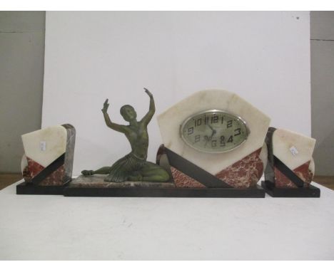 An Art Deco French marble mantle clock with two matching garnitures. The oval dial inscribed 'Bedu-Bailly Valencas' and havin
