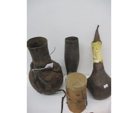Vintage African tribal vessels and artefacts to include a wooden honey pot with leather ends and straps, a wooden tapered ves