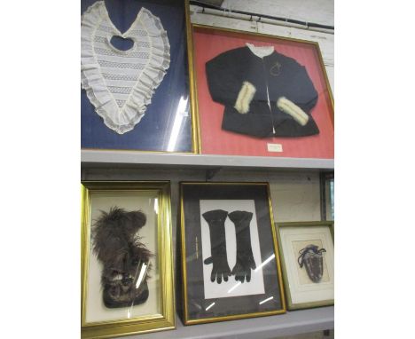 Five framed items of vintage clothing comprising a pair of 1920s ladies black crocheted evening gloves, an early 20th century