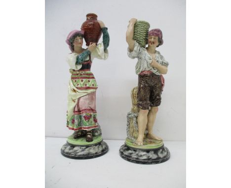 A pair of Bernhard Bloch figures of a woman carrying a vase and a man carrying a basket, each on a marble effect base, with i