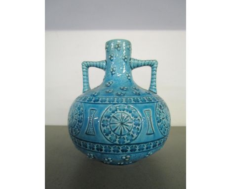 A Burmantofts faience pottery, twin handled vase of compressed globular form with short narrow neck, turquoise glazed and dec