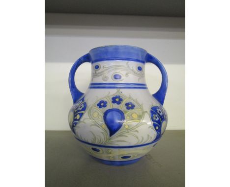 A William Moorcroft design for Moorcroft Pottery, a twin handled vase decorated in a Persian style floral pattern, matt glaze