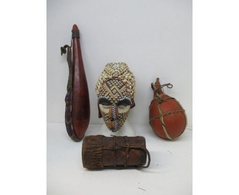 Vintage African tribal vessels and artefacts to include an elongated gourd with coloured bead and leather strapwork, a gourd 