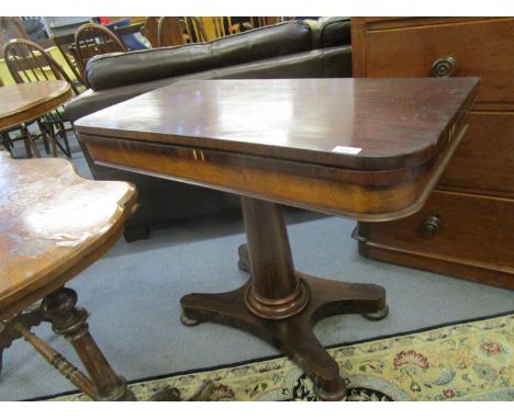 A Regency mahogany veneered fold-over card table, on tapering column and quatrefoil base with bun shaped feet, 28 1/2" x 36" 