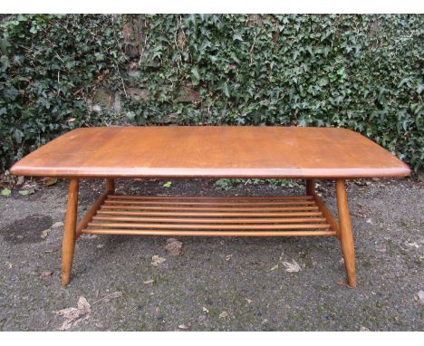 An Ercol mid century style coffee table in light beech and ash, with magazine rack undertier and elliptical legs, 14 1/2" x 4