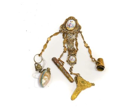 Late 19th Century Gilt Metal Chatelaine with oval enamel mount to the clip of a young girl, hung with five chains with attach