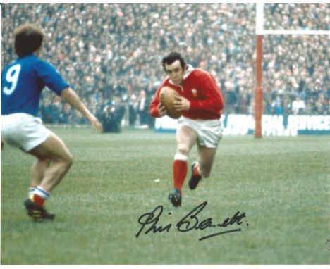 Phil Bennett signed 10x8 colour action shot photo playing for Wales against France in the Five Nations. A Welsh international