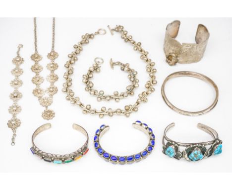 A GROUP OF FOREIGN MOSTLY SILVER JEWELLERY (9)Comprising a collar necklace with a matching bracelet, a filigree necklace with