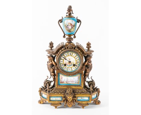 A FRENCH ORMOLU AND PORCELAIN MANTEL CLOCKIn the Louis XVI style, circa 1890The case modelled with an urn and cherub above, t