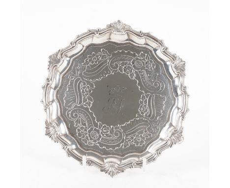 A GEORGE III SILVER SALVEROf shaped circular form, having a shell and pie-crust rim in the Chippendale style, the centre mono
