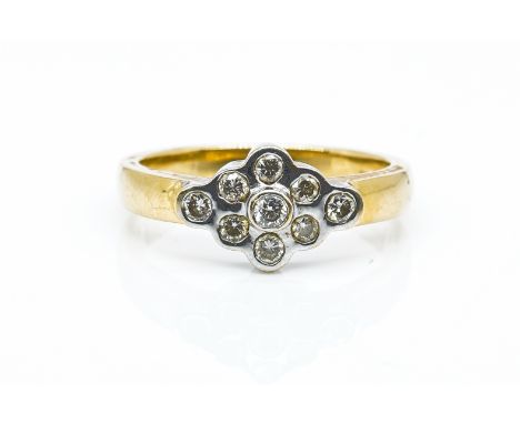 AN 18CT GOLD AND DIAMOND NINE STONE CLUSTER RINGMounted with circular cut diamonds, in a navette shaped design, detailed 18 K