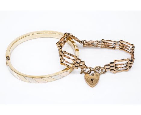 A 9CT GOLD GATELINK BRACELET AND A 9CT THREE COLOUR GOLD OVAL HINGED BANGLE (2)The gate bracelet fitted with a heart shaped p