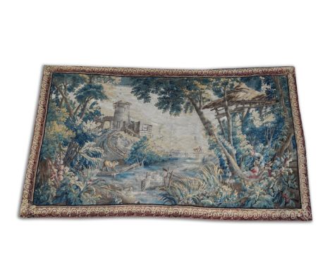 A FLEMISH VERDURE TAPESTRY DEPICTING AN AMOROUS COUPLE18th Century  Woven in wools, depicting a wooded landscape with mill, f