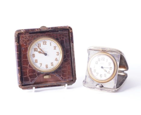 TWO TRAVELLING CLOCKS (2)Comprising an Asprey silver cased rectangular folding clock, the circular enamel dial detailed Aspre