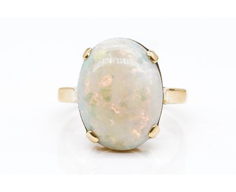 AN OPAL RINGClaw set with an oval opal, in yellow gold, detailed 18 CT, ring size M and a half, gross weight 5.3 grams, with 