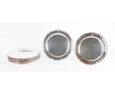 A GEORGE III SET OF TWELVE SILVER PLATES (12)Each of shaped circular form, decorated with a beaded rim, crest and motto engra