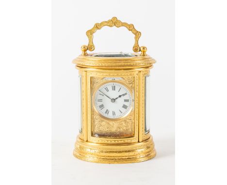 A FRENCH ENGRAVED GILT BRASS OVAL MINIATURE CARRIAGE CLOCKAttributed to Drocourt, No. 20297, circa 1890The oval engraved case