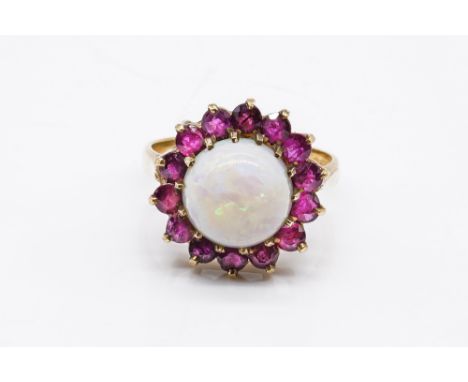 A 9CT GOLD, OPAL AND RUBY CLUSTER RINGClaw set with the circular opal in a surround of circular cut rubies, London 1975, ring