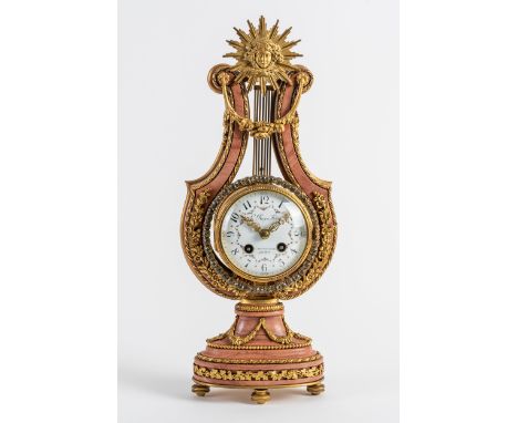 A FRENCH ORMOLU AND PINK MARBLE LYRE CLOCKIn the Louis XVI style, circa 1900The lyre-shaped case modelled with a sunburst and