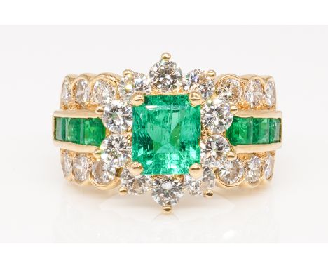 AN EMERALD AND DIAMOND DRESS RINGFeaturing a principal emerald cut emerald (weight approx 1.30 carats) in a four claw setting