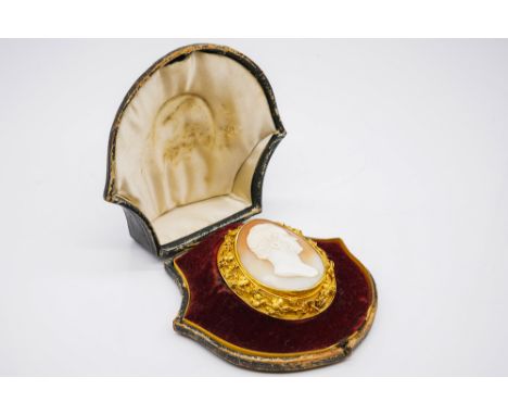 A VICTORIAN GOLD MOUNTED OVAL SHELL CAMEO BROOCHCarved as the portrait of a gentleman, the border of the mount decorated with