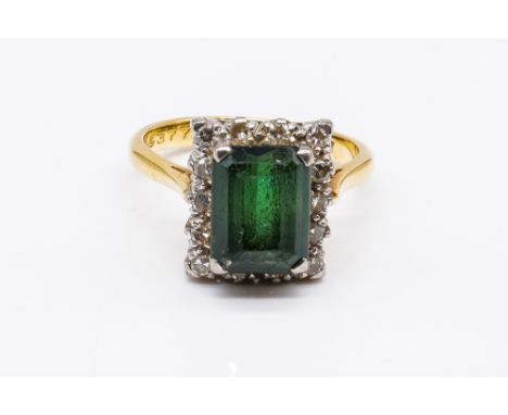 A GOLD, DIAMOND AND GREEN TOURMALINE SET RECTANGULAR CLUSTER RINGClaw set with the rectangular step cut green tourmaline with