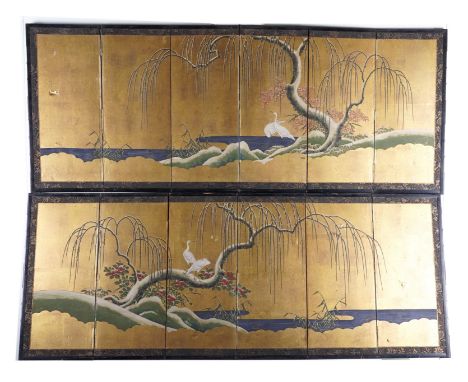 A PAIR OF JAPANESE GILT AND POLYCHROME DECORATED SIX FOLD SCREENS (2)Meiji Period, Late 19th Century   Depicting trees and cr