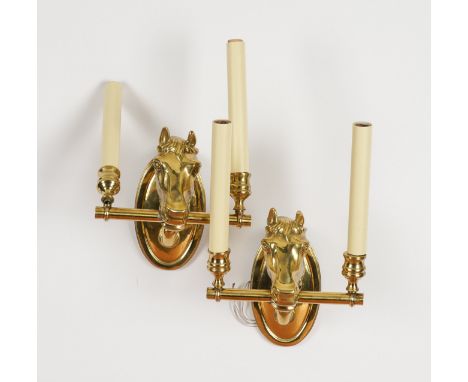 JOHN STEFANIDIS: A PAIR OF GILT-METAL HORSE HEAD TWIN LIGHT WALL APPLIQUES (2)Modern Each oval backplate mounted with a horse