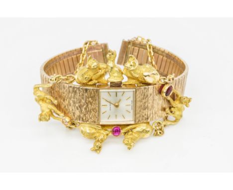 A JEAN RENET 9CT GOLD, DIAMOND AND RED GEM SET LADY'S BRACELET WRISTWATCHThe signed square silvered dial with gilt baton hour