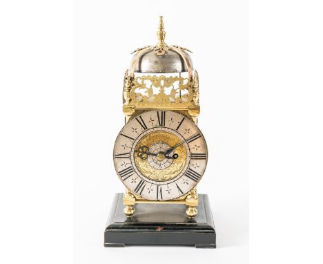 A MINIATURE BRASS LANTERN CLOCK WITH ONE-IN-PASSING HOUR STRIKEThe dial inscribed Tho. Tompion, LondonOf typical form, surmou