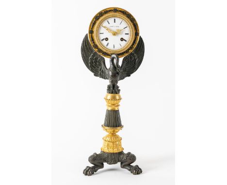 AN EMPIRE REVIVAL MANTEL CLOCKCirca 1865Modelled as an outstretched swan supporting the dial, on a tapering fluted triform st