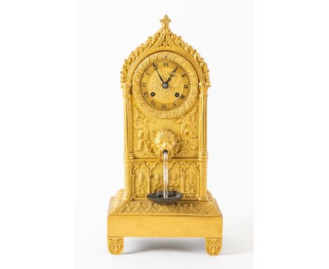 A CHARLES X AUTOMATON MANTEL CLOCKThe arched case cast with foliage, enclosing the gilt dial, above a mask head and automaton