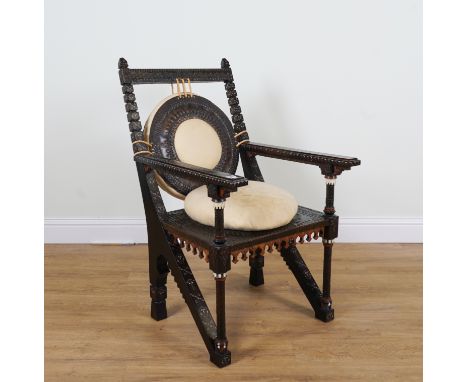 IN THE MANNER OF CARLO BUGATTI; A HARDWOOD AND METAL VENEERED BONE AND PEWTER INLAID OPEN ARMCHAIR64cm wide; 108cm high