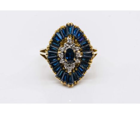 A GOLD, SAPPHIRE AND DIAMOND SHAPED OVAL CLUSTER RINGClaw set with the principal marquise shaped sapphire at the centre, in a