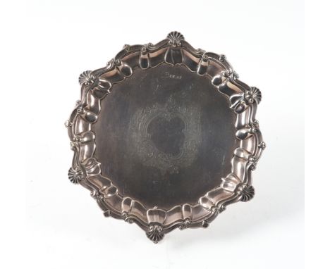A SILVER SALVEROf shaped circular form, having a shell and pie-crust rim in the Chippendale style, engraved with a rococo car