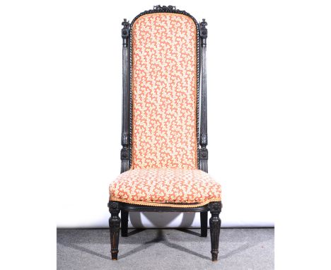 A Victorian ebonised prie dieu, cotton print upholstery, ribbon carved cresting, fluted legs, 104cm.