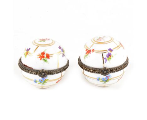 A pair of Continental porcelain trinket boxes with metal mounts, spherical form, gilt and transfer print floral decoration, 5